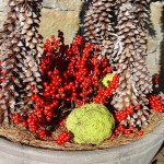 Pine cones, winterberries and osage orange in pot.