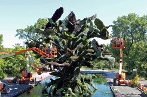Maintaining The Bird Tree Mosaiculture with aerial ladder trucks.