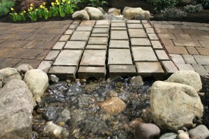 Water running through channels in the pavers at The Greenskeeper's display.